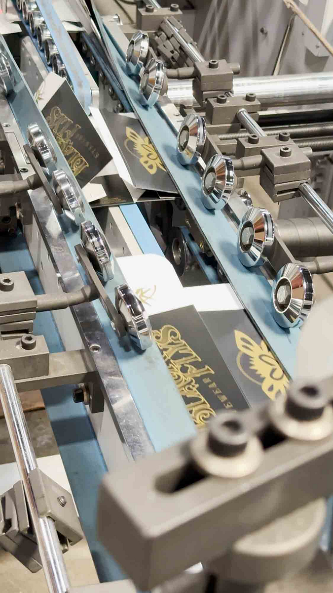 Image of Black Flys sunglasses boxes getting folded on the SBL Platinum PG-100C folder-gluer.